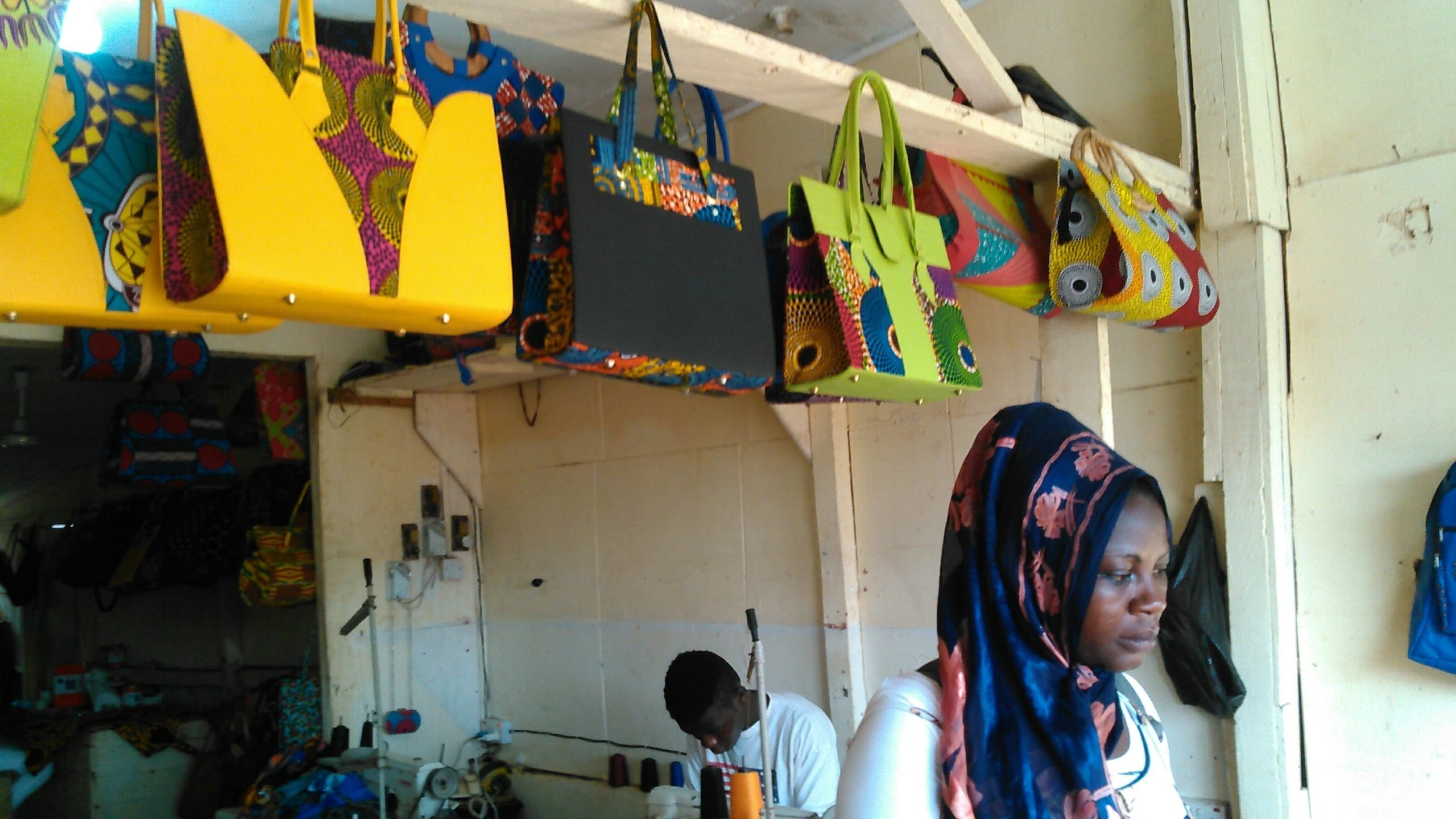 Ghana artisan creating handcrafted goods using traditional techniques for fair-trade global marketplace.