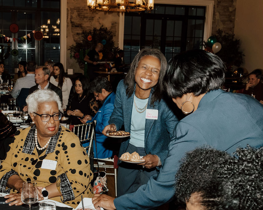 Candid photo of guests connecting at event supporting where to donate to Akron education initiatives.